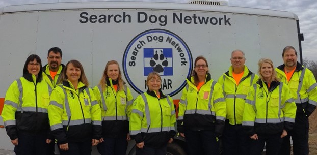 A group of people in safety jackets at the Search Dog Network