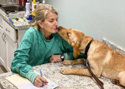 Dr. Stewart being kissed by Georgie the dog