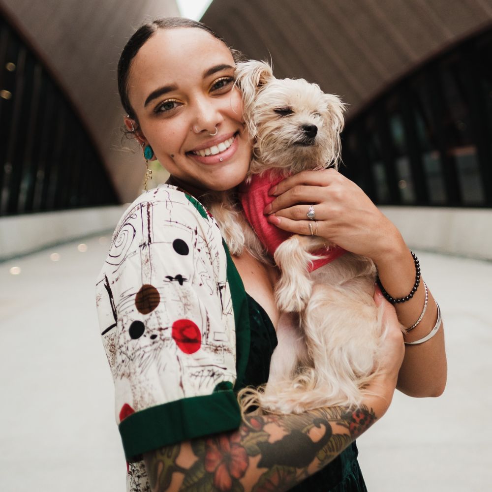 Smiling woman holding small dog